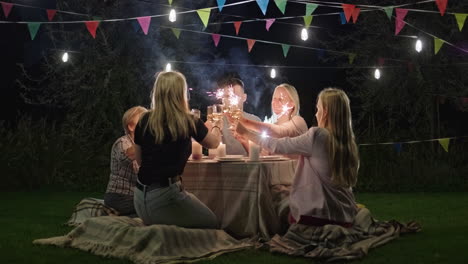 family picnic dinner with sparkler toasts