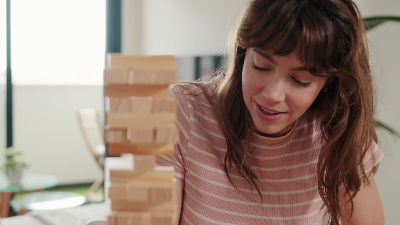 Couple Having Fun Playing Jenga At Home