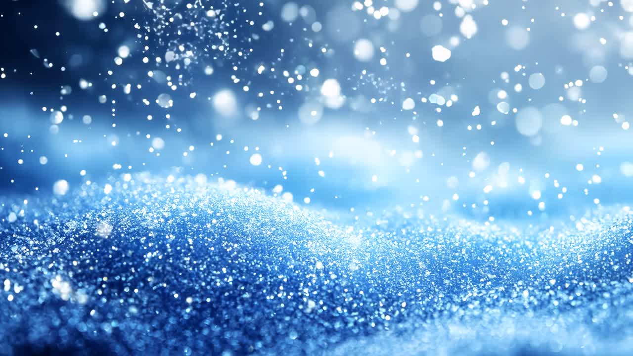 A blue snow covered hill with snowflakes falling on it. The snow is falling in a way that it looks like it's dancing in the air