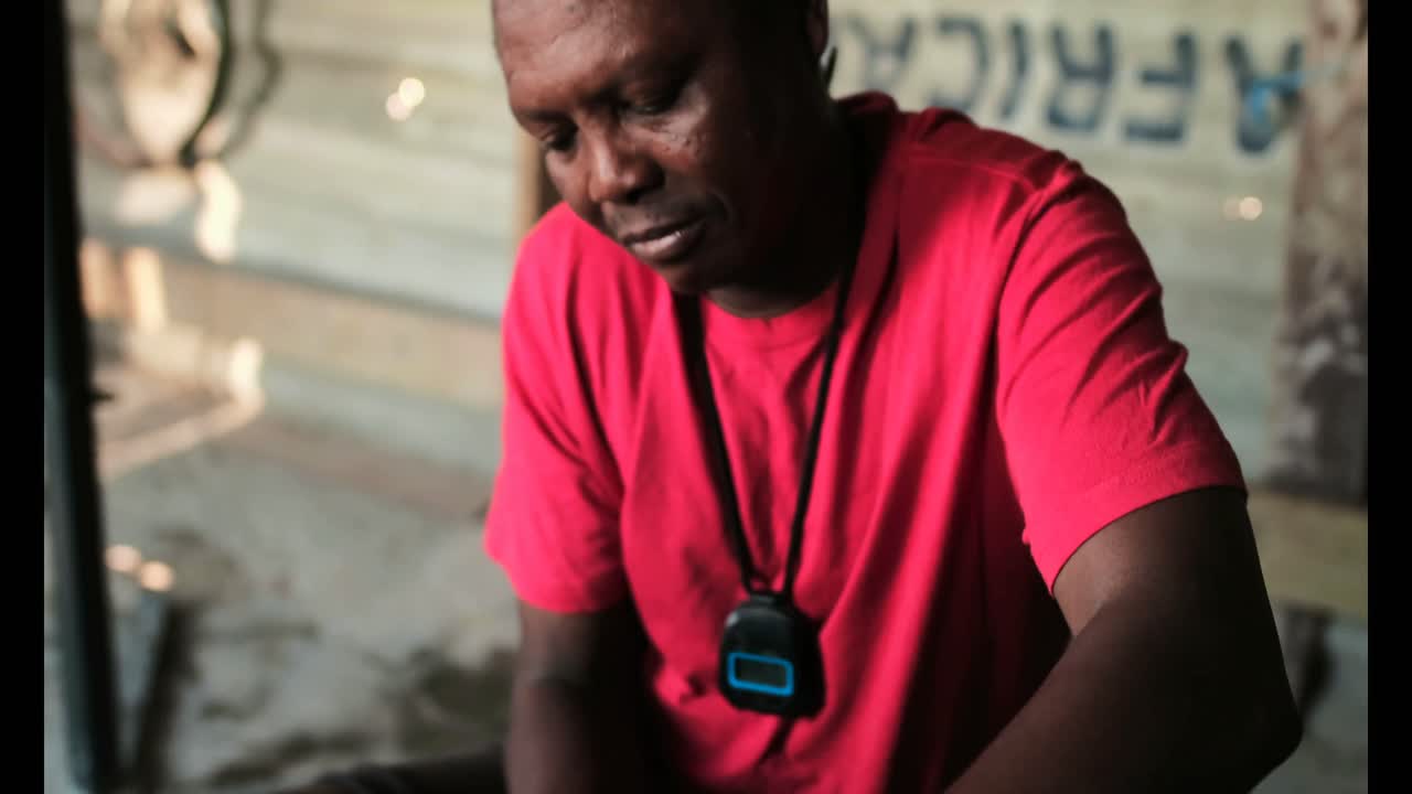 아프리카계 미국인 남성 트레이너가 체육관 4k에서  ⁇ 드  ⁇ 을 착용하는 권투 선수를 돕고 있습니다.