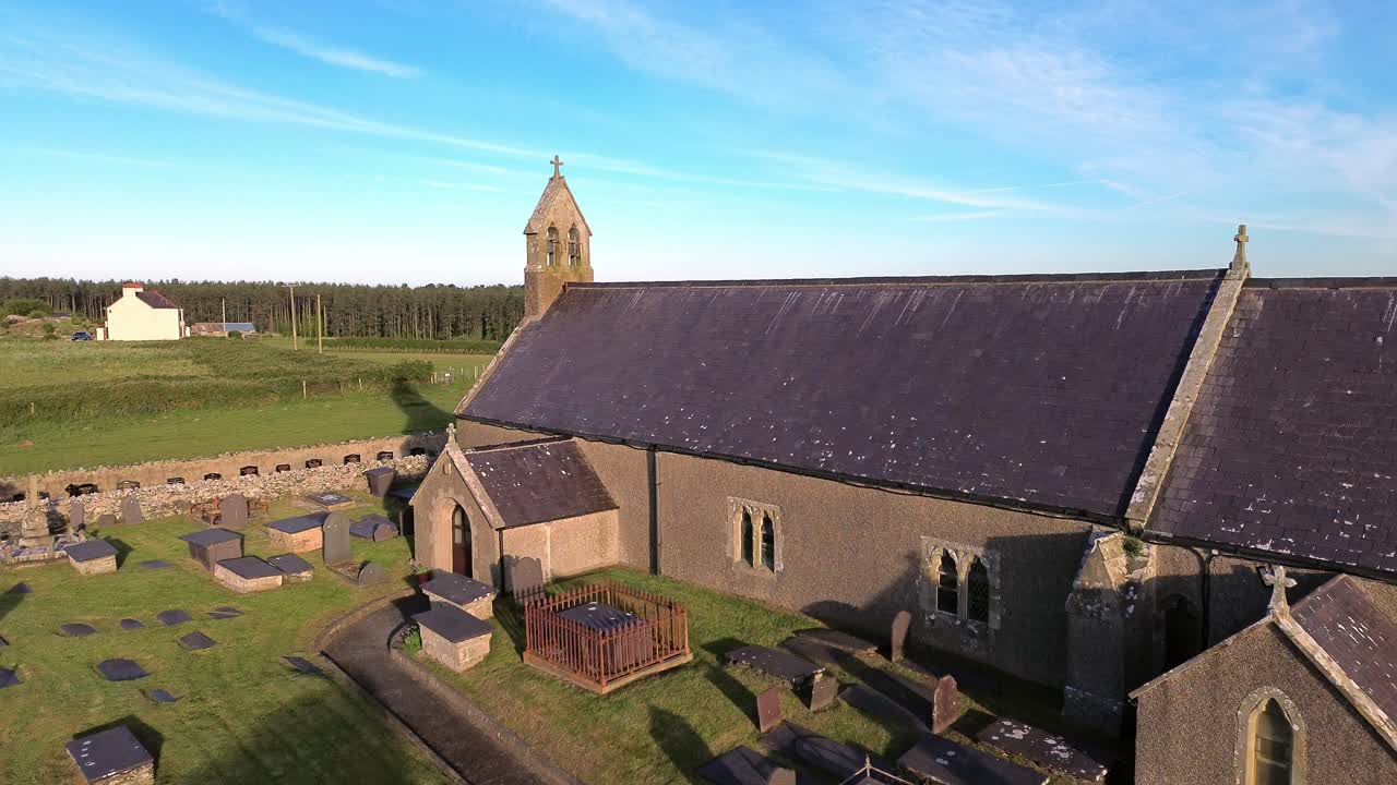 St Peters church in rural Newborough aerial view towards Welsh chapel in early morning sunrise