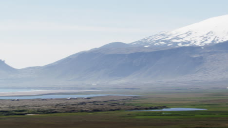 coastline and snow mountains, snaefellsnes peninsula, iceland, wide pan right