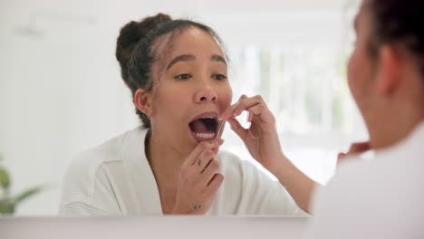 Mirror,-dental-or-bathroom-woman-flossing