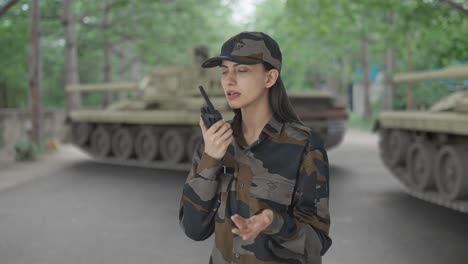 indian woman army officer talking on walkie talkie