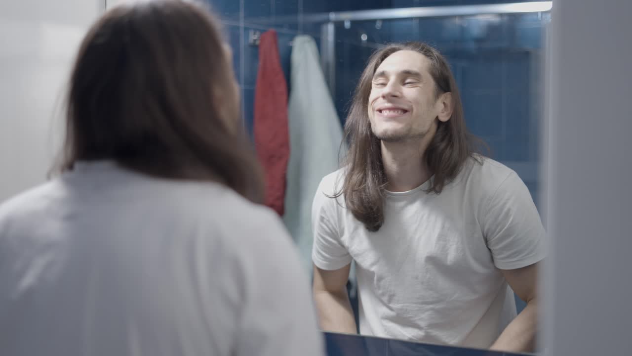 Man looking at himself in the bathroom mirror