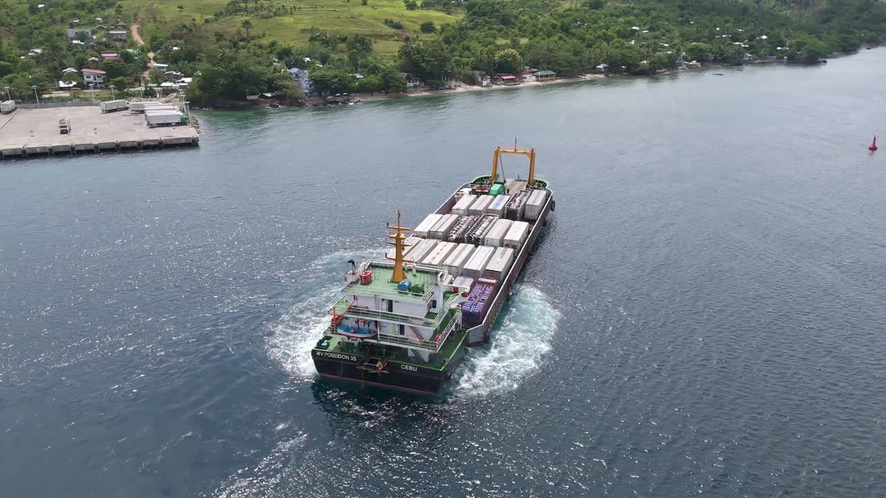 Cargo ferry departing Lipata Ferry Port with lush coastline and open water in the background