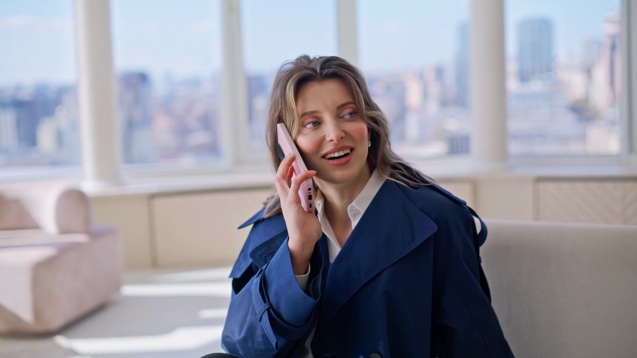 Stylish woman phone call luxury apartment. Lady chatting smartphone city view.