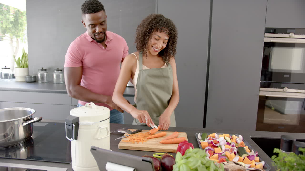 Preparing vegetables, couple cooking together in modern kitchen, enjoying time