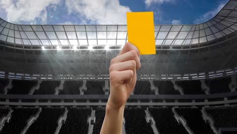 animation of referee holding yellow card on pitch in sports stadium