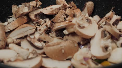 motion controlled slow motion shot of mushrooms in a cooking pan