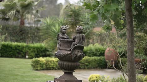 ornamental cherub garden statue surrounded by greenery location irrelevant