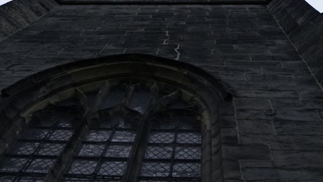 looking up at stained windows on old english church medium shot