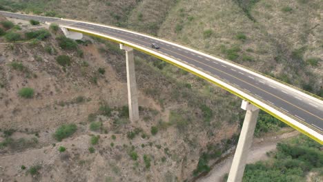 aerial-view-of-large-white-truck-crossing-a-big-bridge-somewhere-in-Mexico
