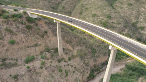 aerial view of large white truck crossing a big bridge somewhere in mexico