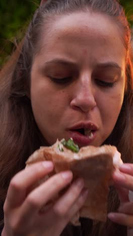 woman eating a falafel snack while exploring downtown Sofia showing real street life vibes