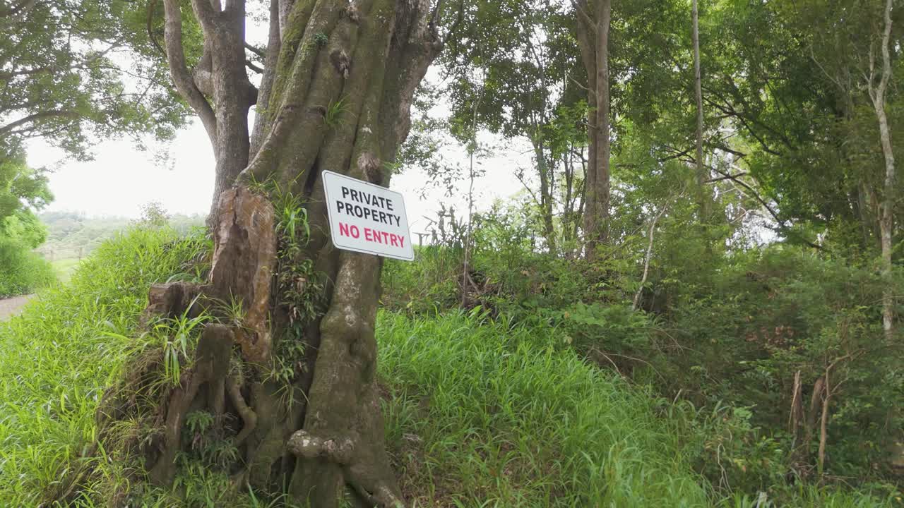 Sign on tree warns against entry