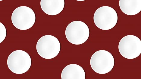 abstract pattern with many white empty plates animated on a dark red background, top view, copy space. cakes move in different directions, 4k