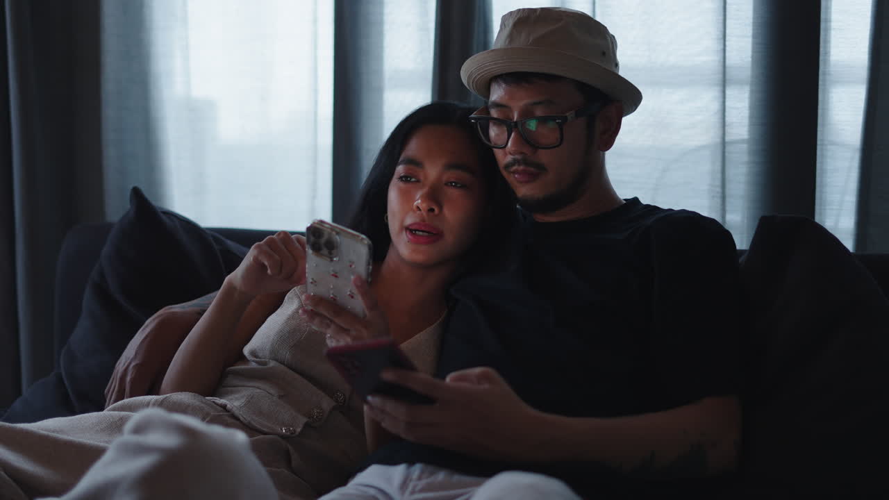 Couple Relaxing on Couch with Phones