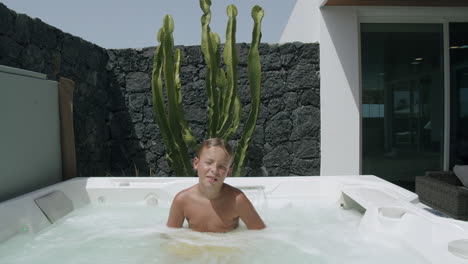 Kid-relaxing-in-outside-spa-bath