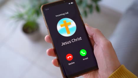 smart phone screen showing incoming call from jesus christ. - closeup shot
