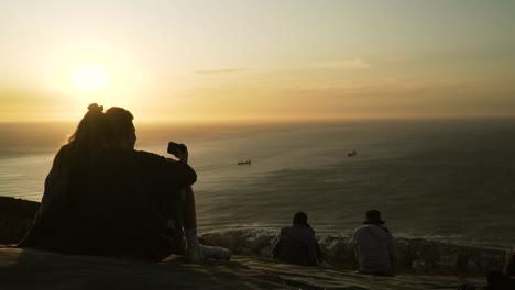 Silhouette-of-Young-Couple-Enjoying-Romantic-Sunset-Above-the-Sea,-Slow-Motion