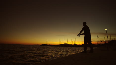 silhouette of a fisherman at sunset