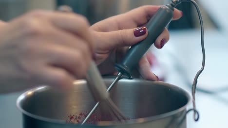 confectioner melts sugar and makes caramel using whisk