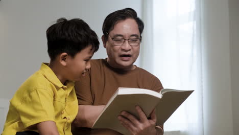 asian man and boy in the bedroom