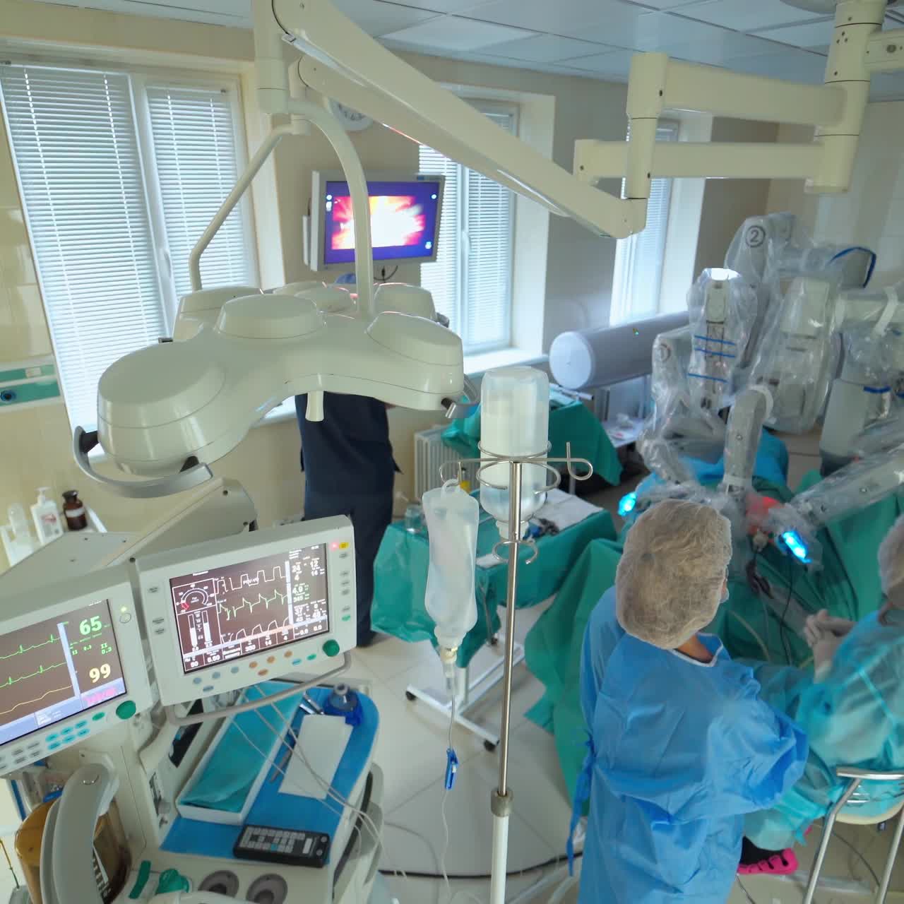 Doctors concentrating on patient during surgery. Resuscitation medicine team wearing protective masks holding steel medical tools saving patient