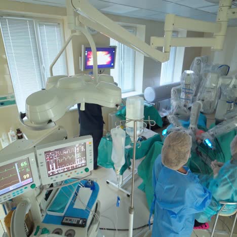 doctors concentrating on patient during surgery. resuscitation medicine team wearing protective masks holding steel medical tools saving patient