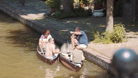 Tourists-Sitting-In-The-Canoe-At-The-Riverbank-During-Sunny-Day
