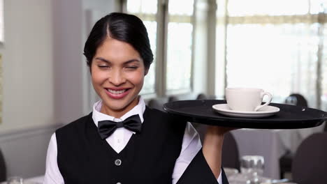 pretty waitress holding a tray with a cup