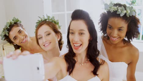 Bridesmaids-and-bride-making-pout-while-taking-a-selfie4K-4k