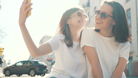 two friends taking a selfie outdoors