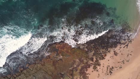 drone shot of bird's eye view over ocean reef and beach rocks in blue bay the entrance central coast australia 3840x2160 4k