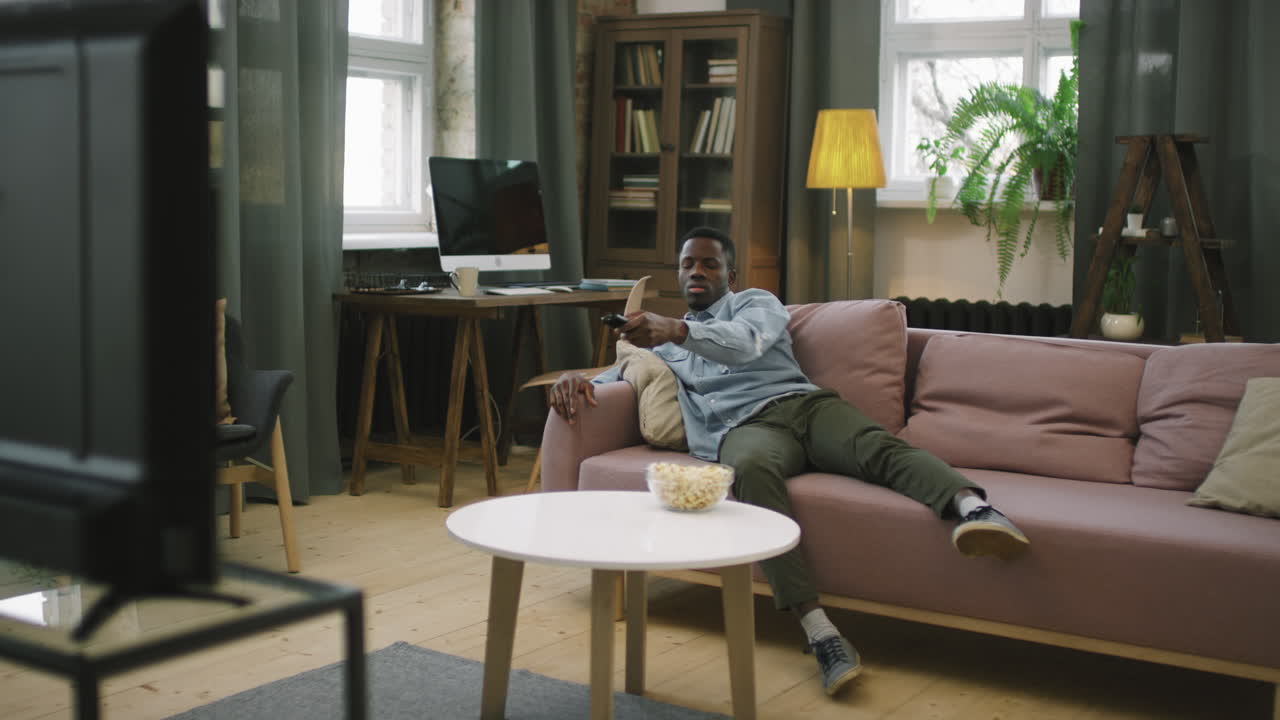 Afro Man Chilling In Front Of TV