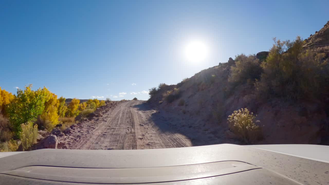 SUV Driving On Dirt Road In Capitol Reef National Park During Autumn In Utah, USA