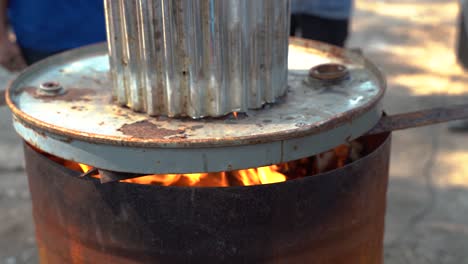 Close-up-Active-Burn-Barrel-with-Fire-Flame-during-Daytime-Outdoors-with-Cover-in-Chiang-Mai-Thailand