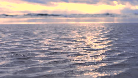 waves at sea during a thunderstorm at sunset