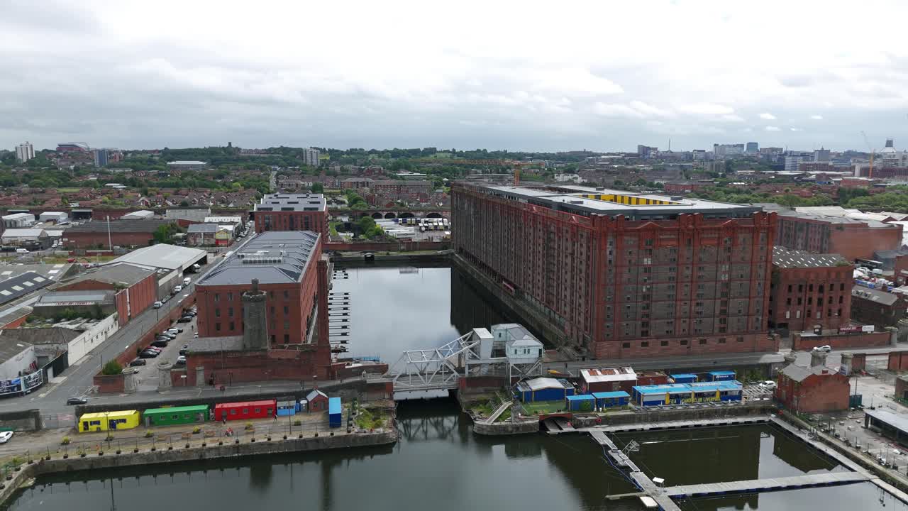 Aerial view of Stanley Dock Tobacco Warehouse and surrounding buildings in Liverpool, UK, showing the canal and cloudy sky