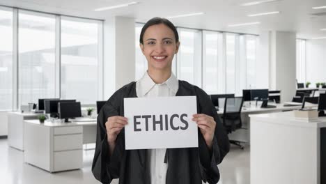 happy indian female lawyer holding ethics banner