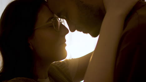 young couple hugging indoors