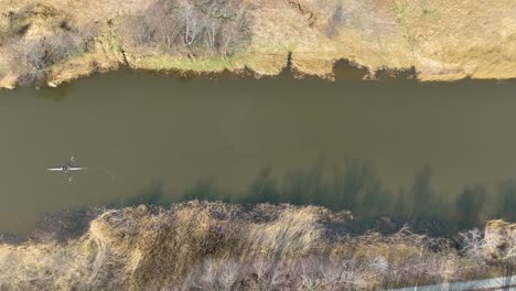 aerial view houw a rower trains to swim in the dane river upstream.