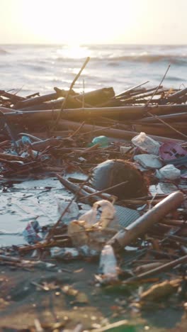 polluted ocean shore with garbage and bottles thrown onto beach from water