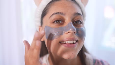 woman applying clay face mask