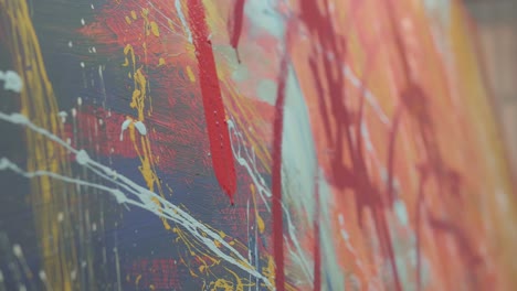holding paint brush and drawing painting with red paint