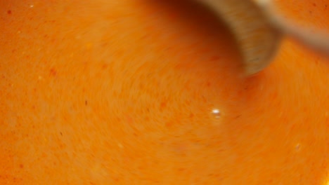 stirring orange soup