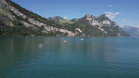 fly over panoramic background of lake mountain and pine broad leaves forest in switzerland in europe nature water sport in vacation outdoor hiking in weekend in summer season fishing and boat riding