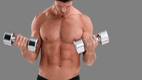 Serious-muscular-man-lifting-dumbbells-