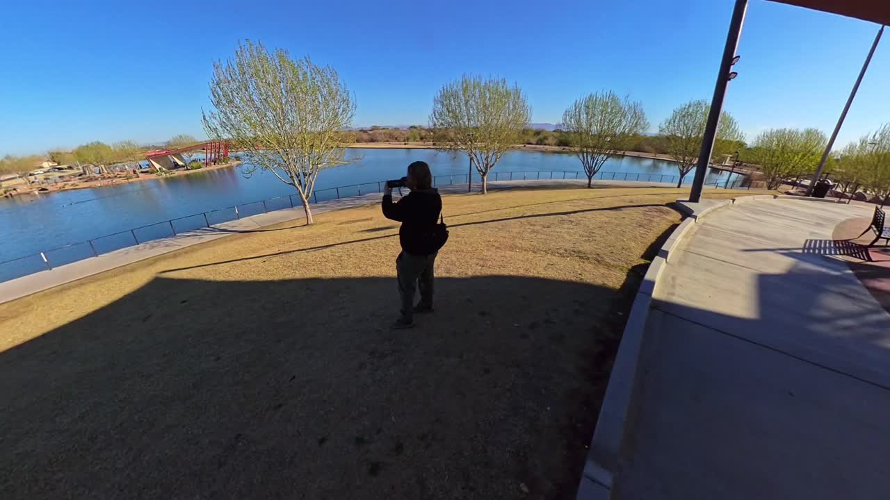 Red haired male photographer taking pictures in Mansel Crater Park in Queen Creek Arizona.